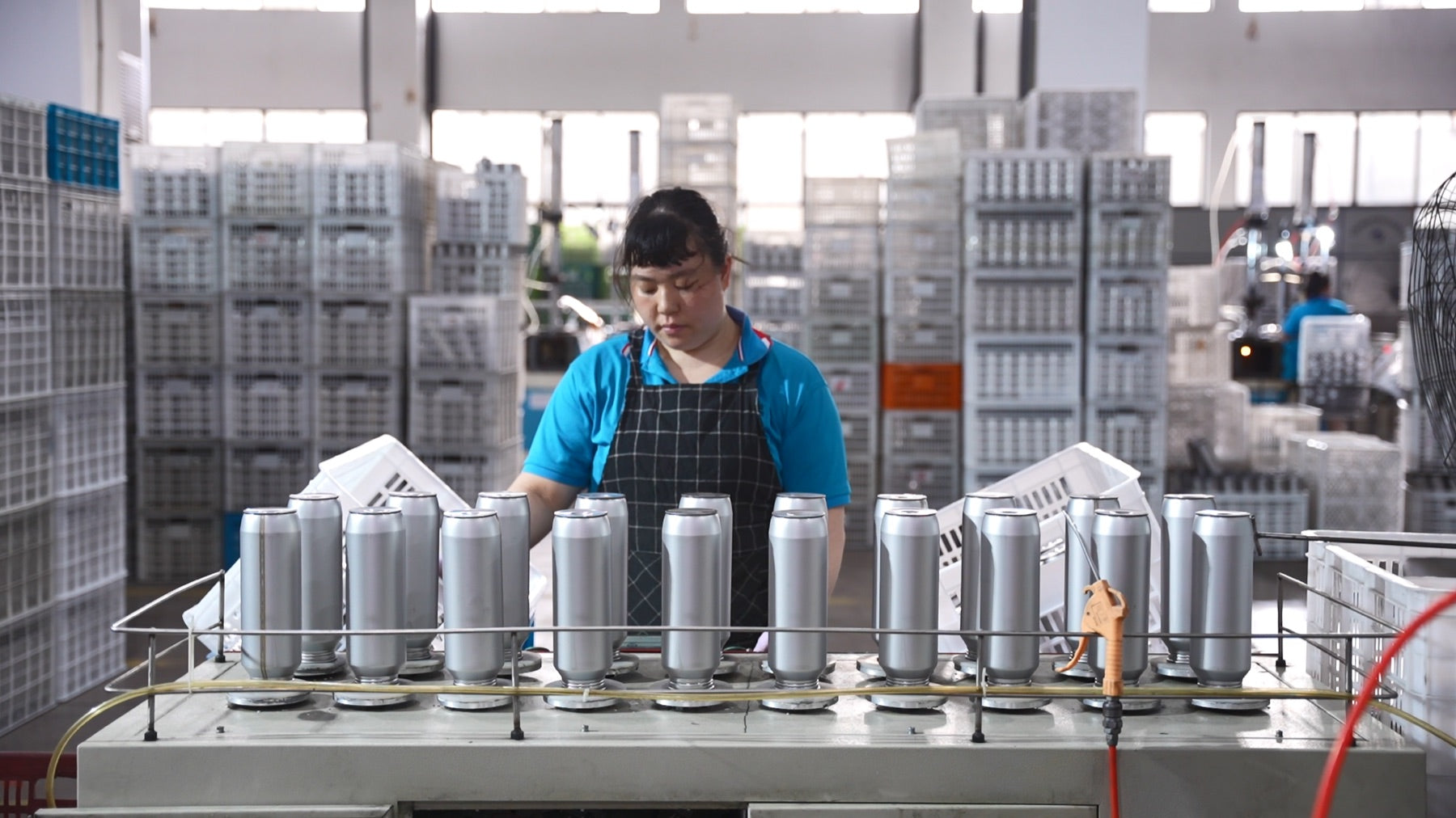 Operator reviewing drinkware during production