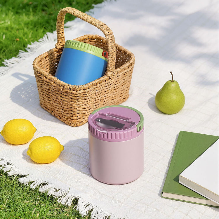12-18oz Food Jar, Oversized Handle, Wide Mouth, Vacuum Insulated. Pink food jar beside a picnic basket and fruit.