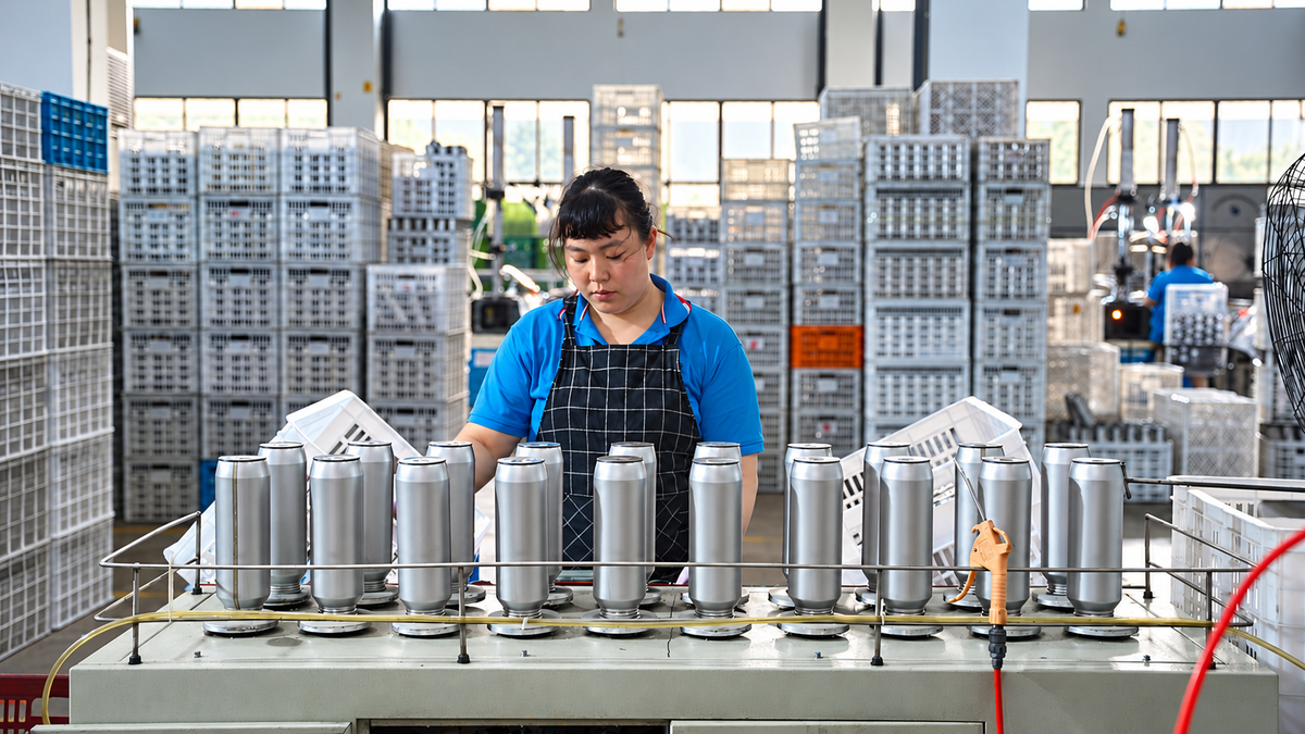 Operator checking drinkware for leaks at a testing station
